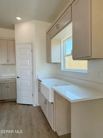 an empty room with a window and a fan