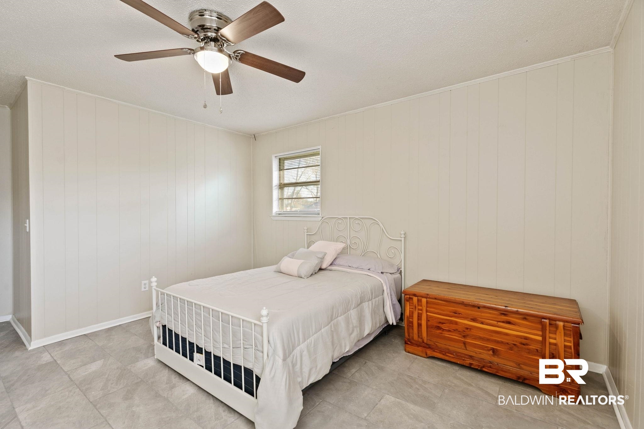 21267 Loop Road Andalusia, AL 36421 - Photo 44 of 72 Bedroom featuring a ceiling fan, ornamental molding, a textured ceiling, and wooden walls