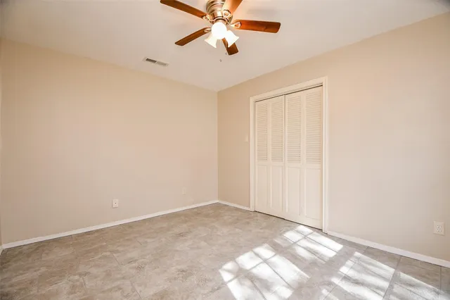 an empty room with windows and closet