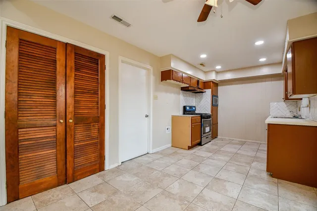 a view of a kitchen with a sink and a large window