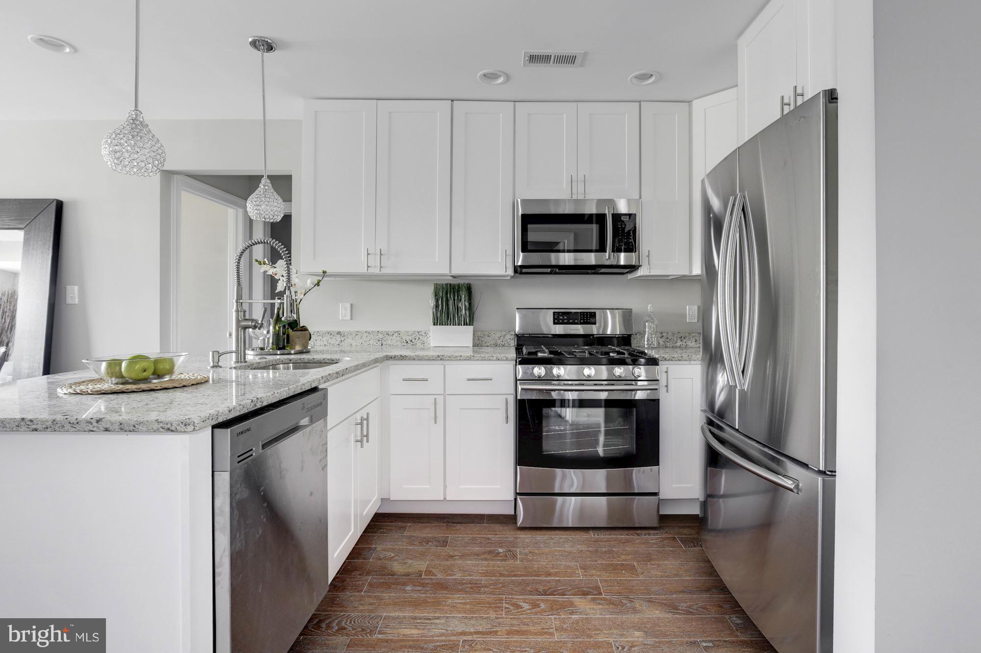 1920 3rd Street Northeast, Unit 7 Washington, DC 20002 - Photo 2 of 21 a kitchen with stainless steel appliances granite countertop a refrigerator sink and stove