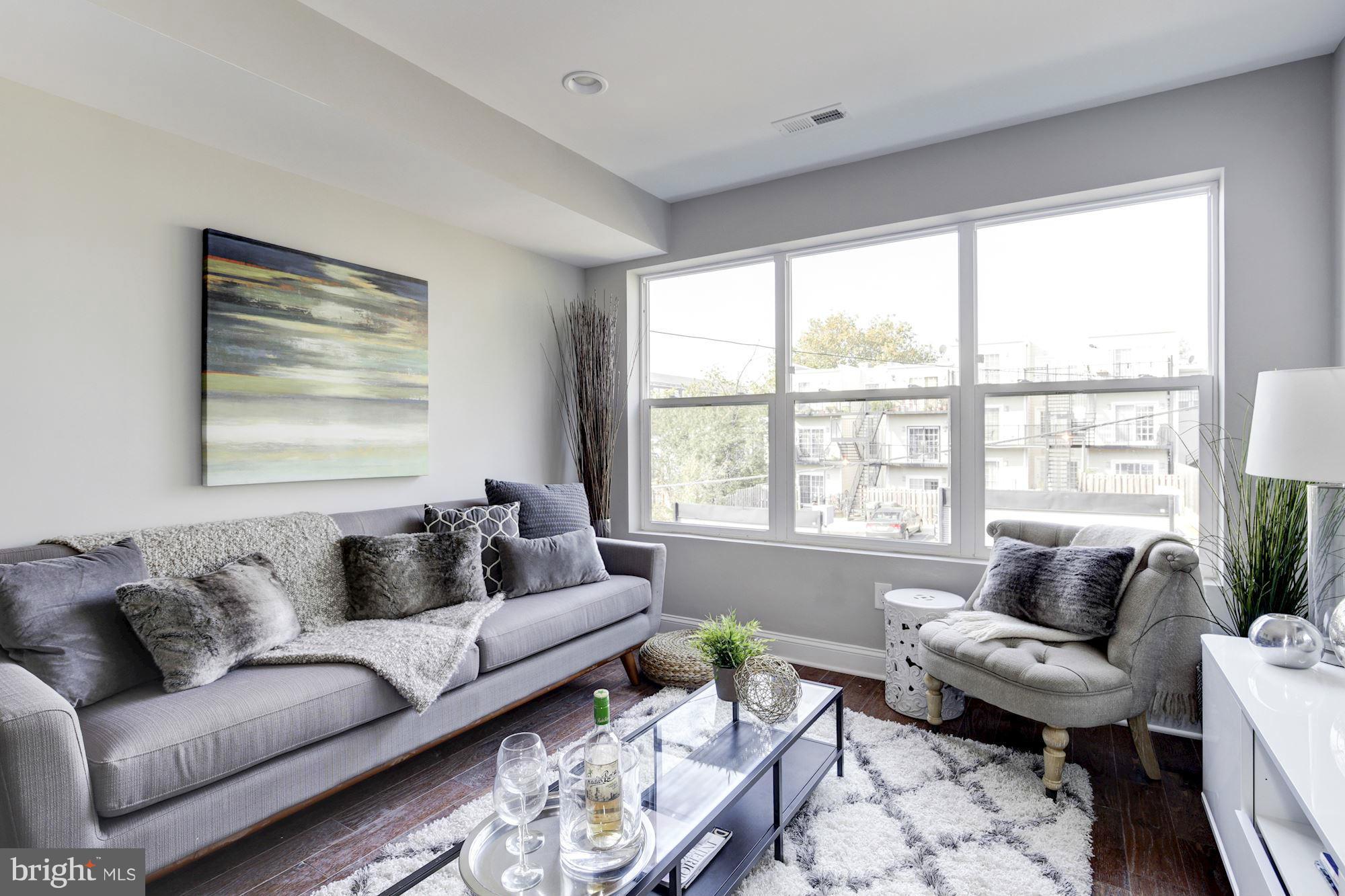 1920 3rd Street Northeast, Unit 7 Washington, DC 20002 - Photo 5 of 21 a living room with furniture and a large window