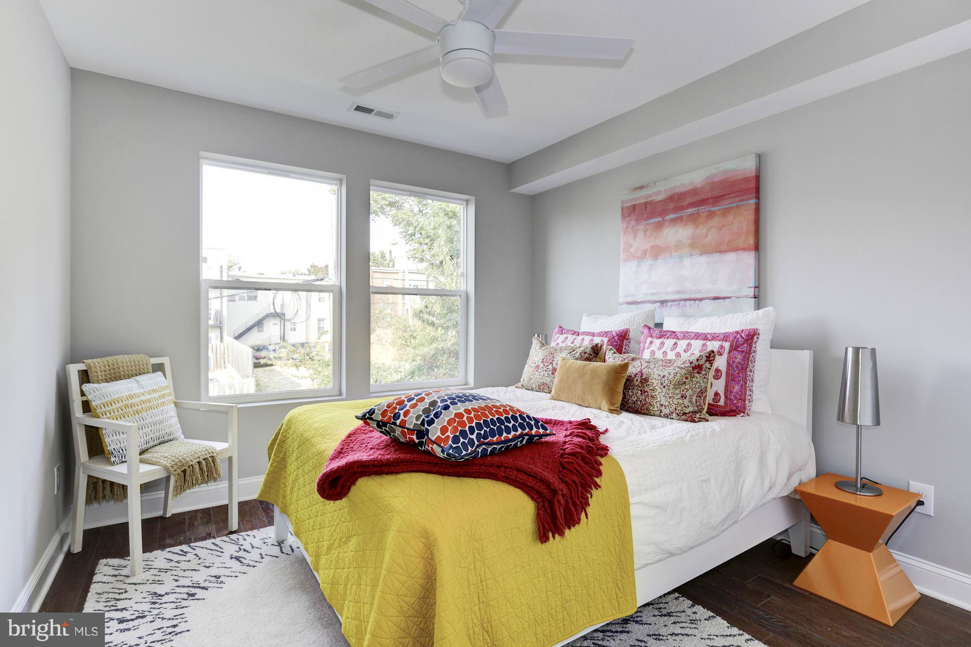 1920 3rd Street Northeast, Unit 7 Washington, DC 20002 - Photo 6 of 21 a bedroom with a bed and wooden floor