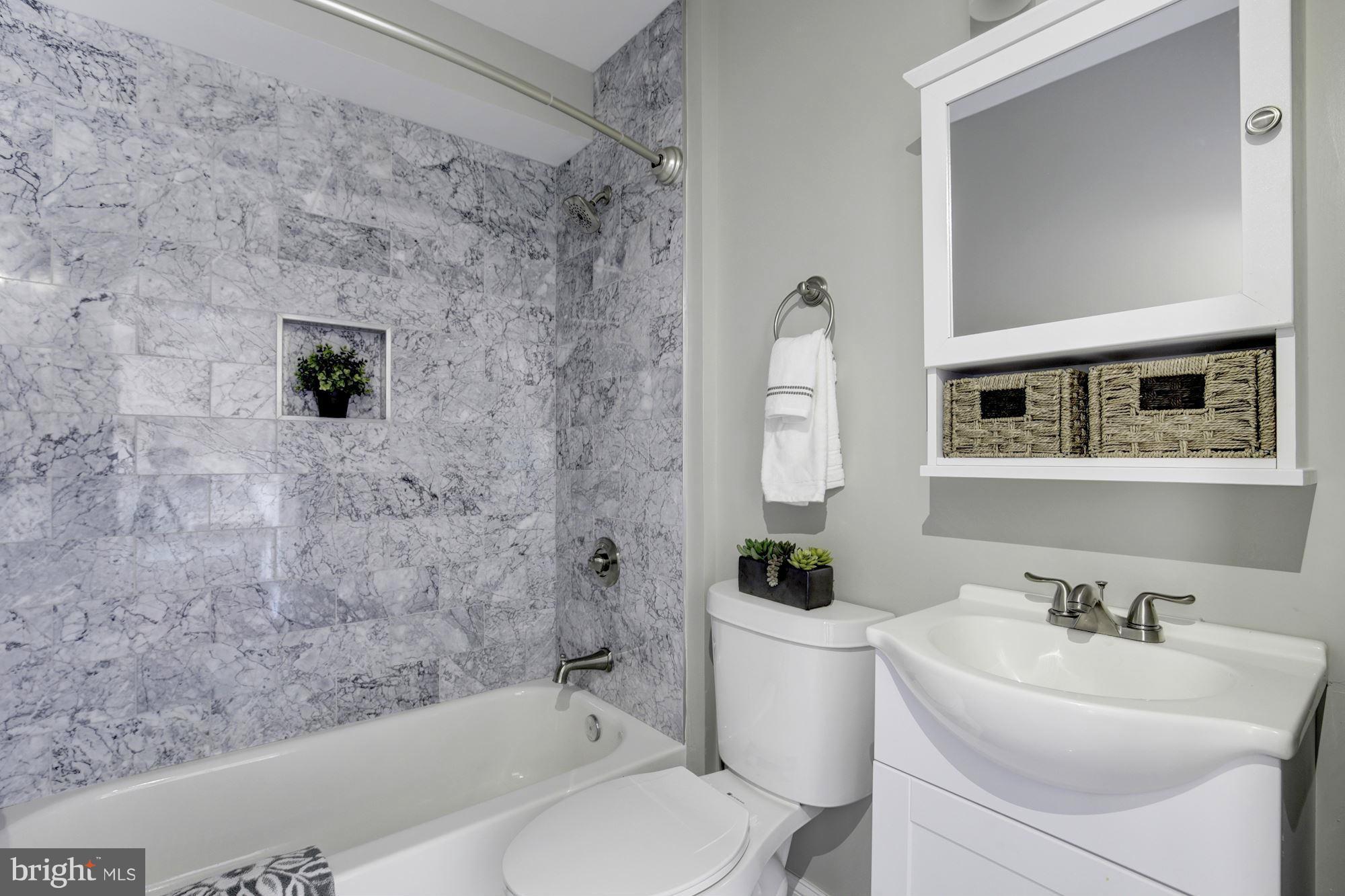 1920 3rd Street Northeast, Unit 7 Washington, DC 20002 - Photo 7 of 21 a bathroom with a sink toilet and shower