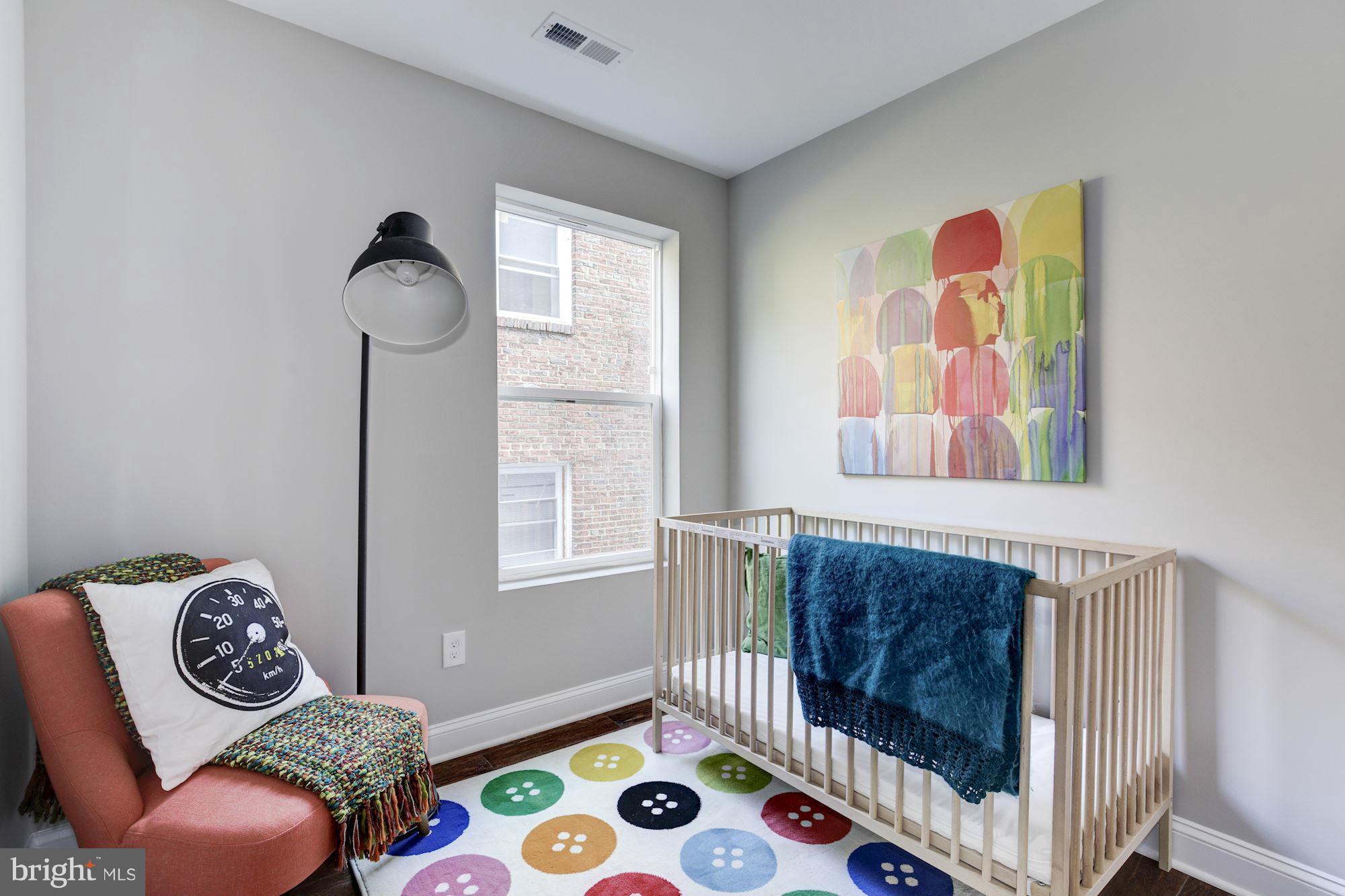 1920 3rd Street Northeast, Unit 7 Washington, DC 20002 - Photo 8 of 21 a bedroom with a bed and a window