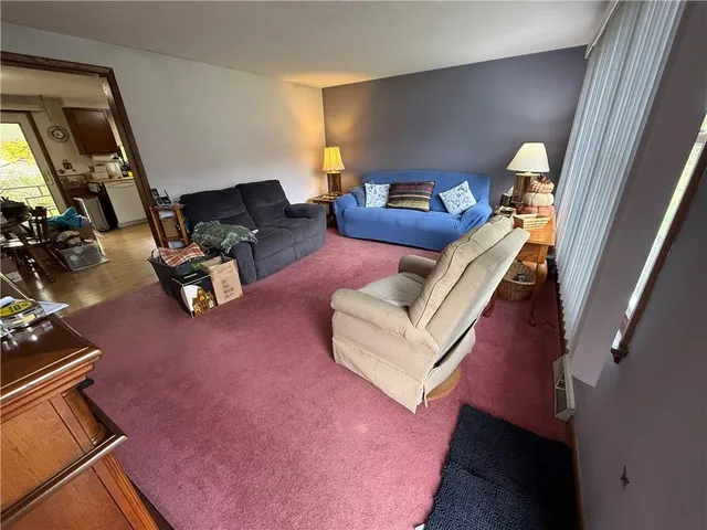 a view of a dining room with furniture a kitchen and chandelier
