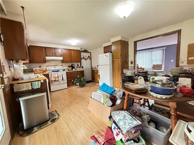 a kitchen with a refrigerator and a stove