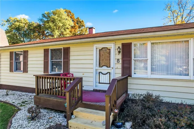 a view of a porch with furniture and a gate
