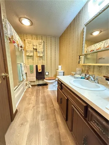 a bed room with a bed and a chair