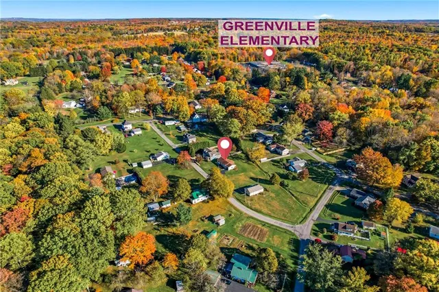 a living room with furniture rug and lamp