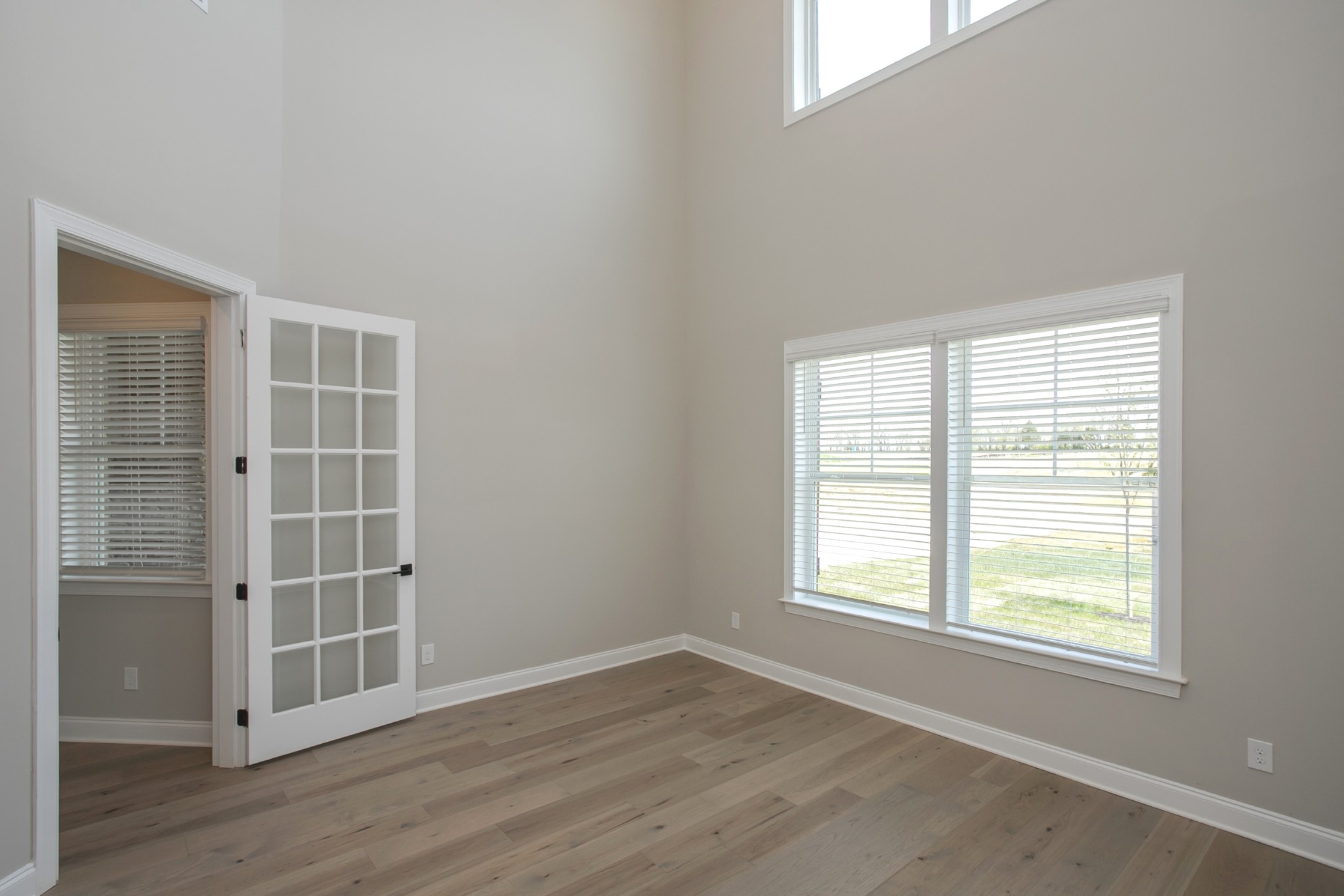 5956 Hunt Vly Drive Spring Hill, TN 37174 - Photo 13 of 53 an empty room with wooden floor and windows
