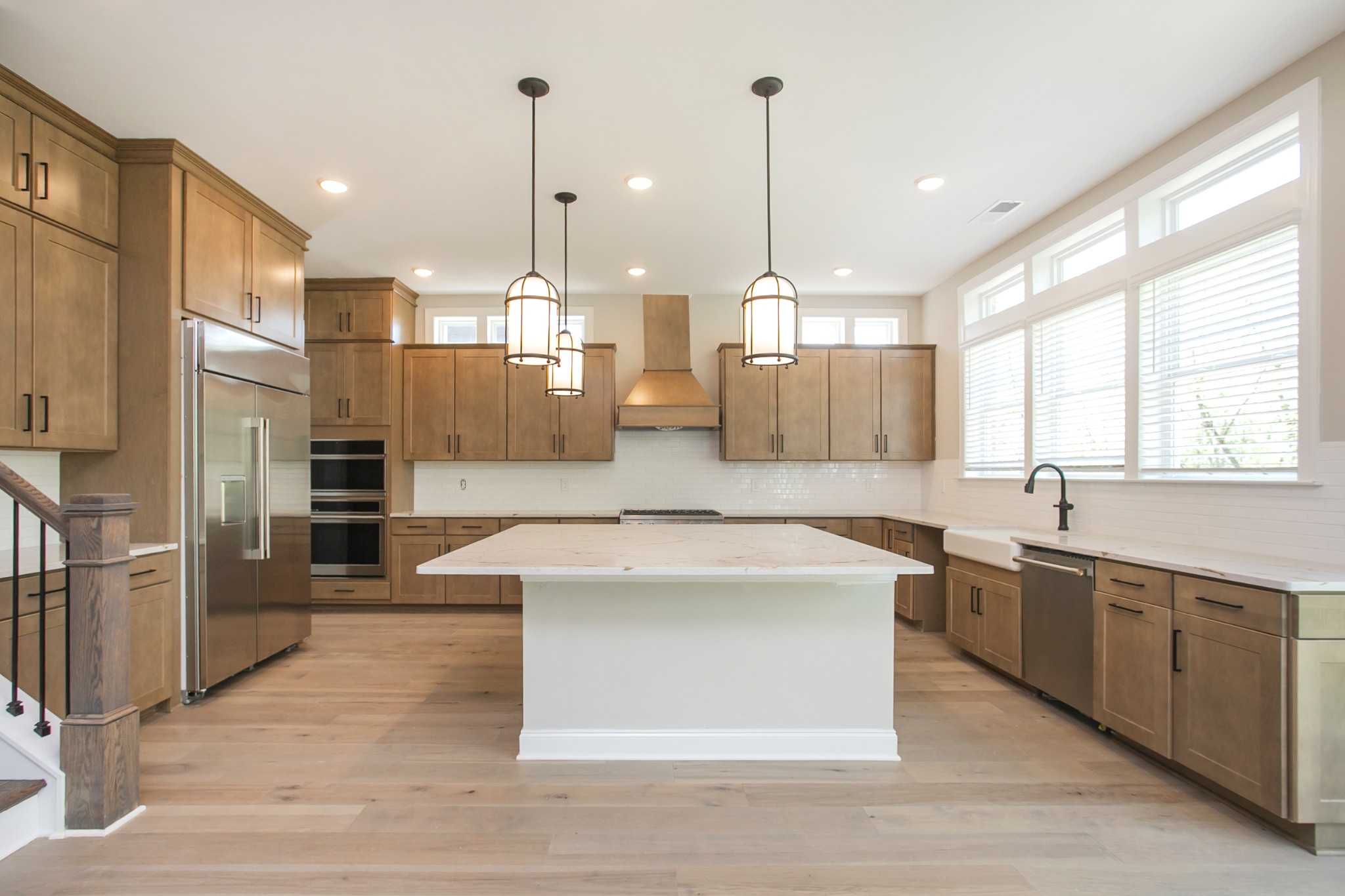 5956 Hunt Vly Drive Spring Hill, TN 37174 - Photo 18 of 53 a large kitchen with stainless steel appliances kitchen island granite countertop a sink a counter space and a window
