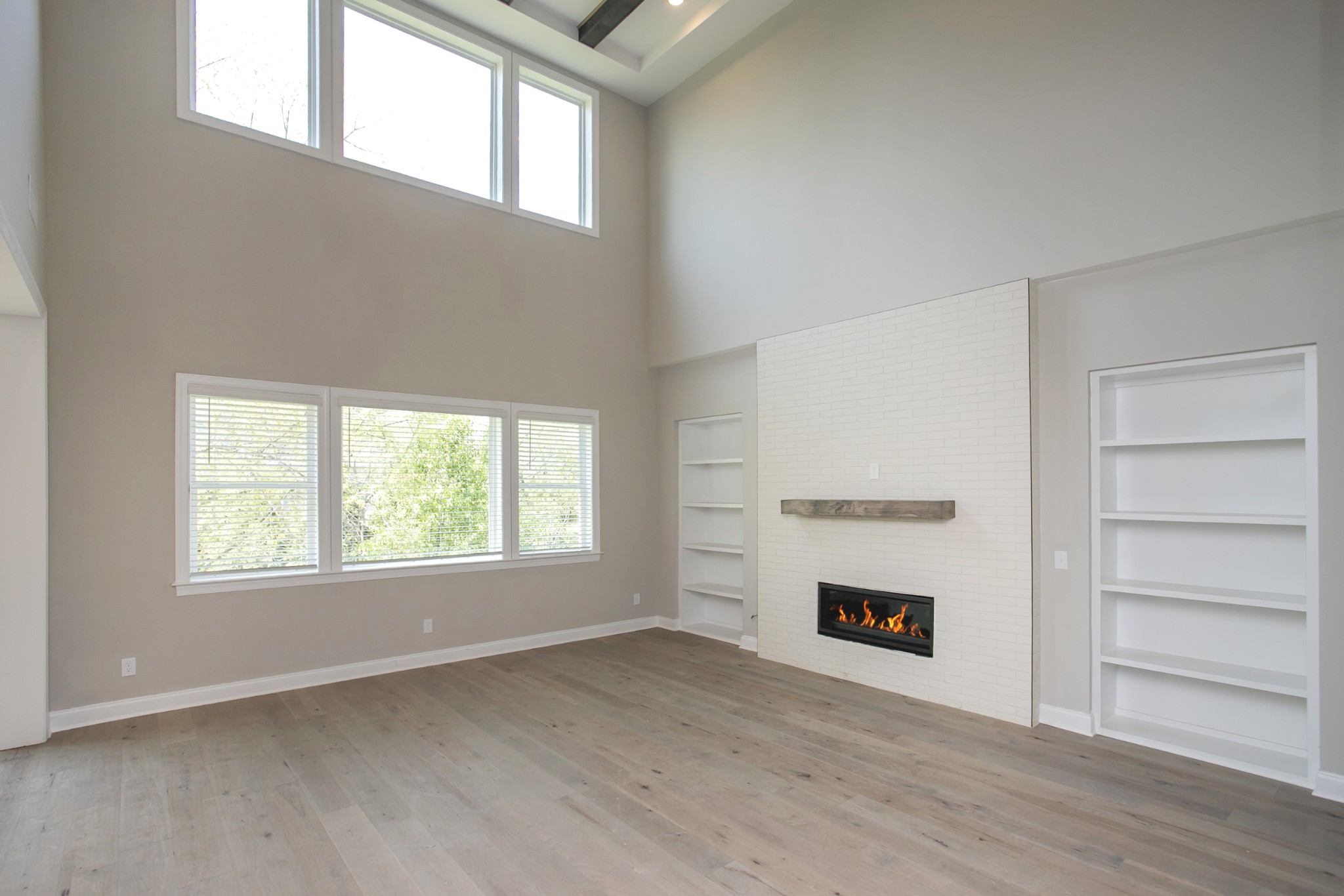 5956 Hunt Vly Drive Spring Hill, TN 37174 - Photo 22 of 53 an empty room with a fireplace a ceiling fan and windows