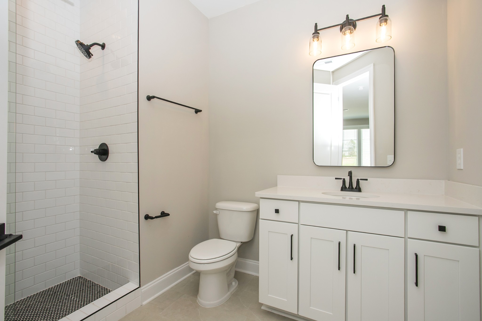 5956 Hunt Vly Drive Spring Hill, TN 37174 - Photo 41 of 53 a bathroom with a toilet sink vanity and mirror
