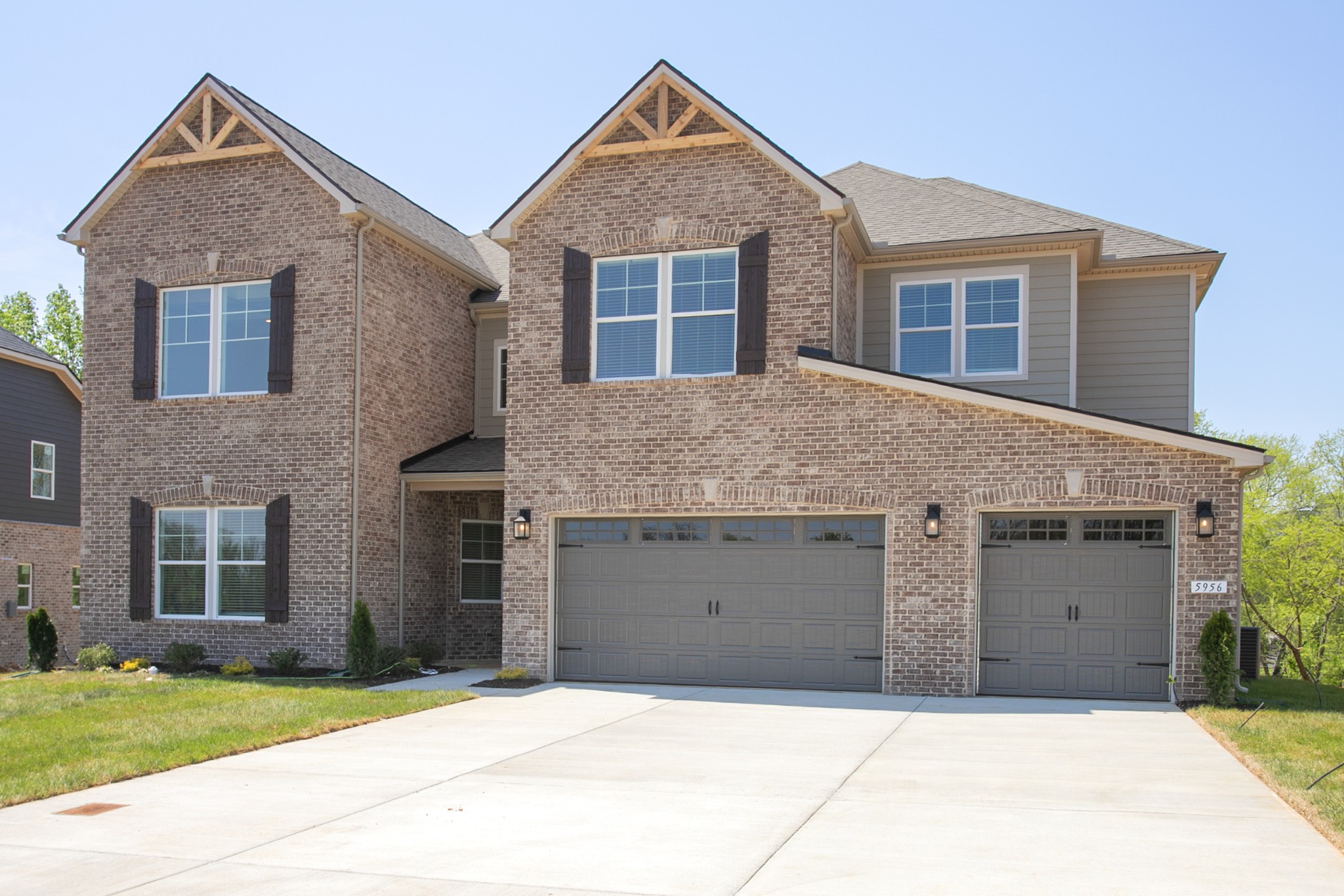 5956 Hunt Vly Drive Spring Hill, TN 37174 - Photo 52 of 53 a front view of a house with a yard and garage