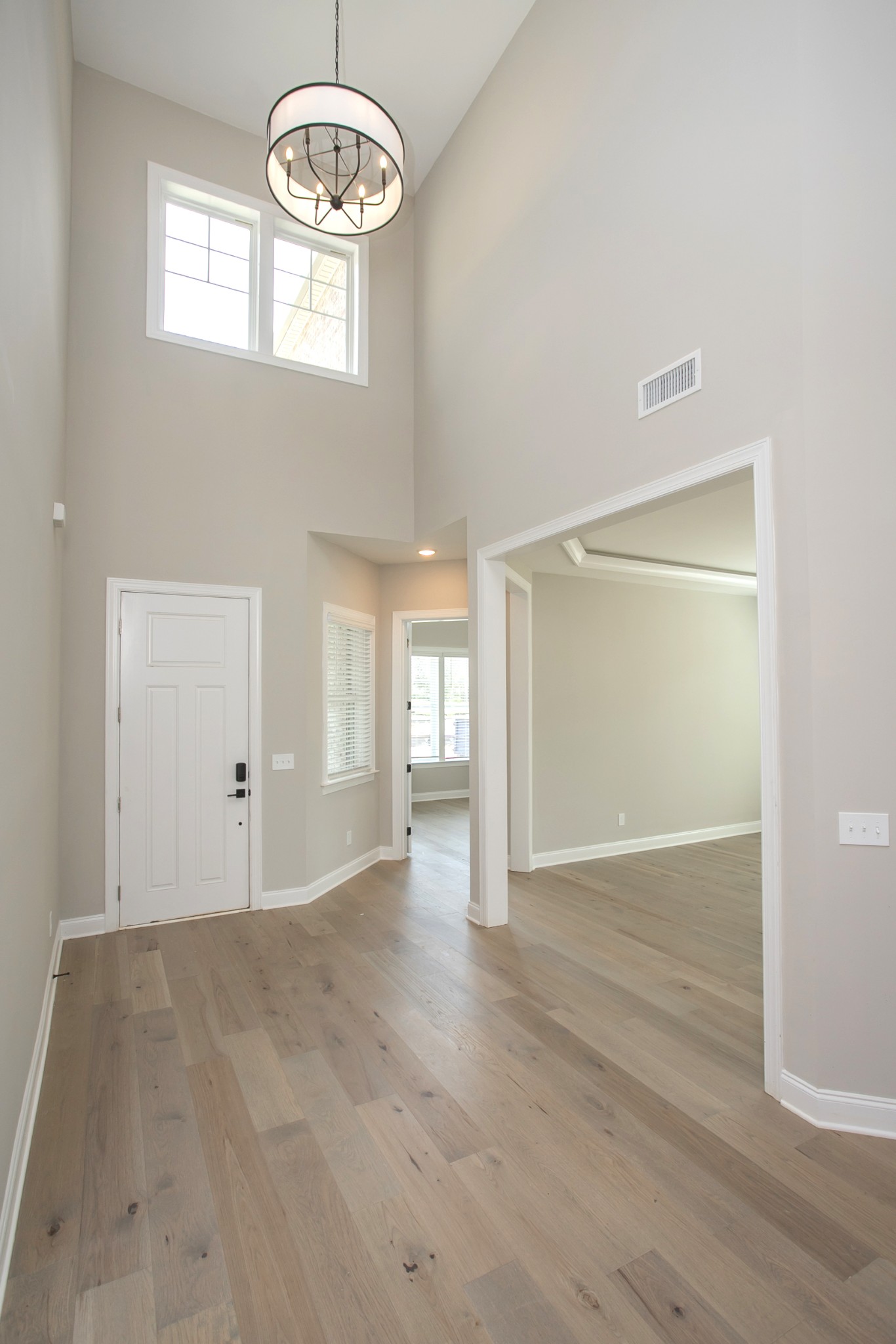 5956 Hunt Vly Drive Spring Hill, TN 37174 - Photo 7 of 53 an empty room with wooden floor mirror and windows