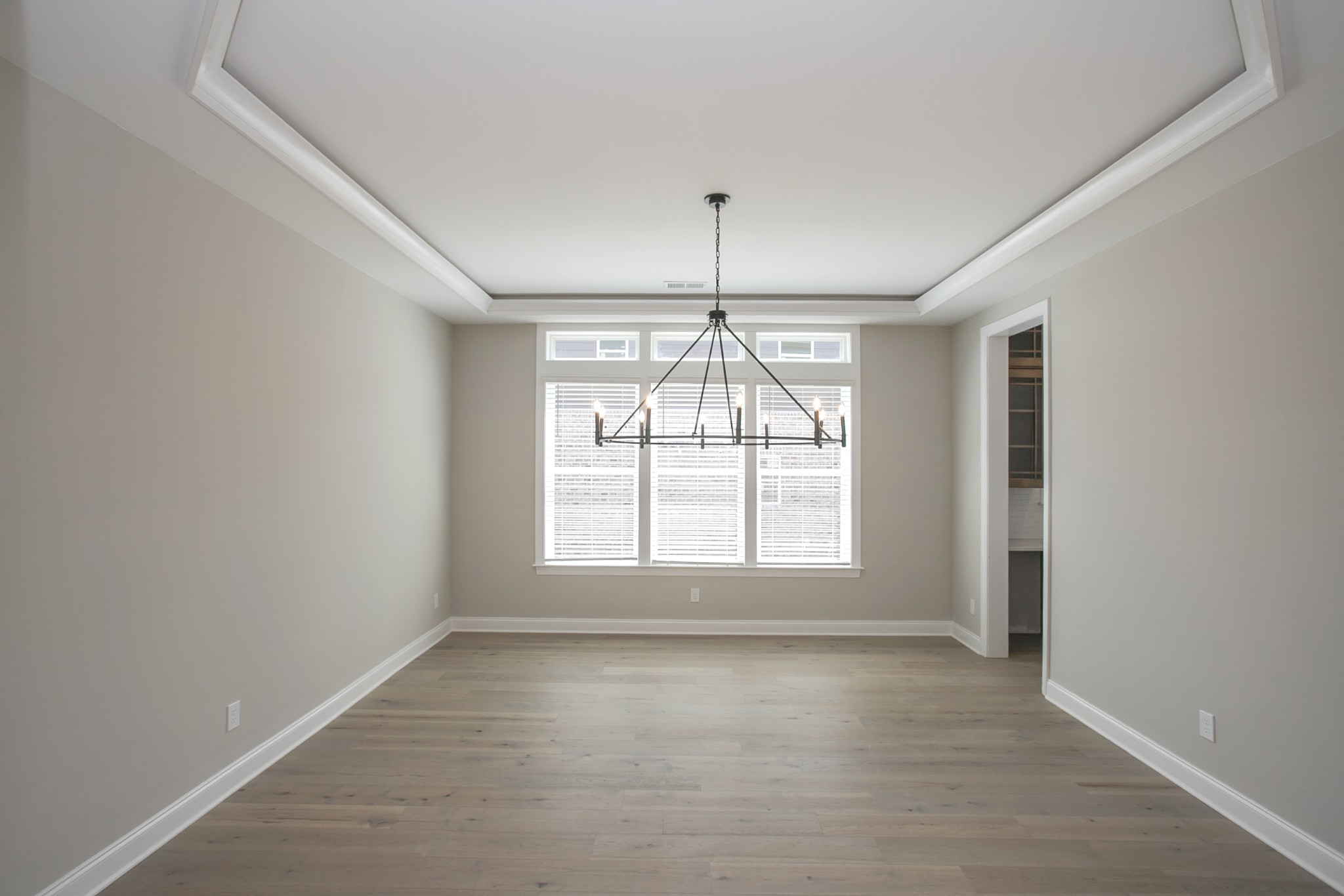 5956 Hunt Vly Drive Spring Hill, TN 37174 - Photo 9 of 53 an empty room with wooden floor and windows