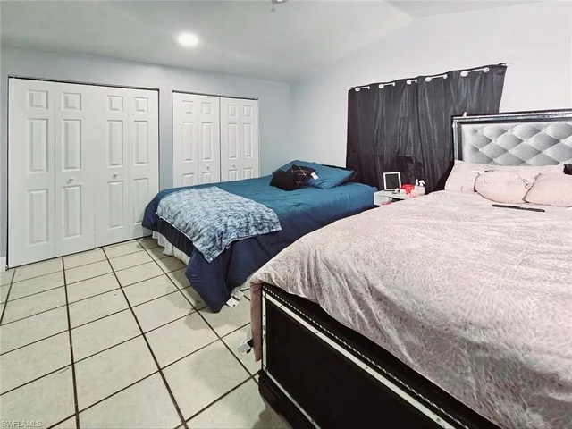 a bedroom with two beds and a dresser