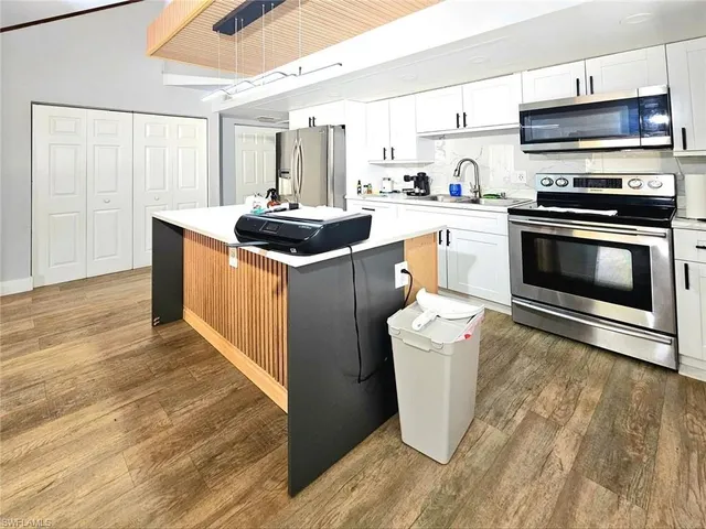 a kitchen with a sink stove and cabinets