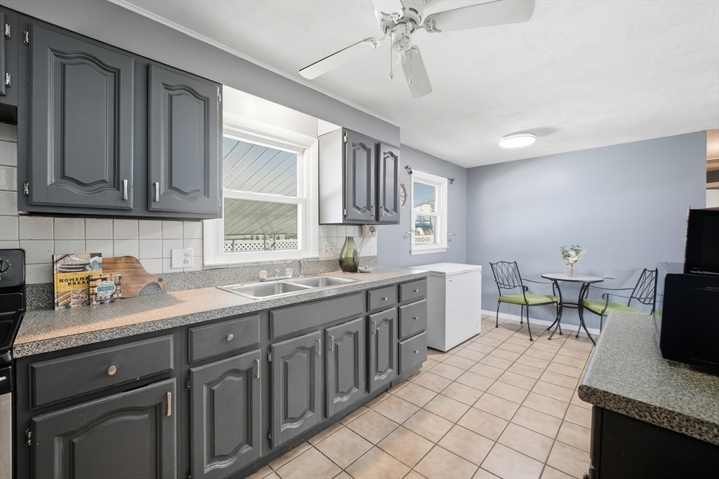 54 Dayton Street Chicopee, MA 01013 - Photo 11 of 25 a kitchen with a sink cabinets and window