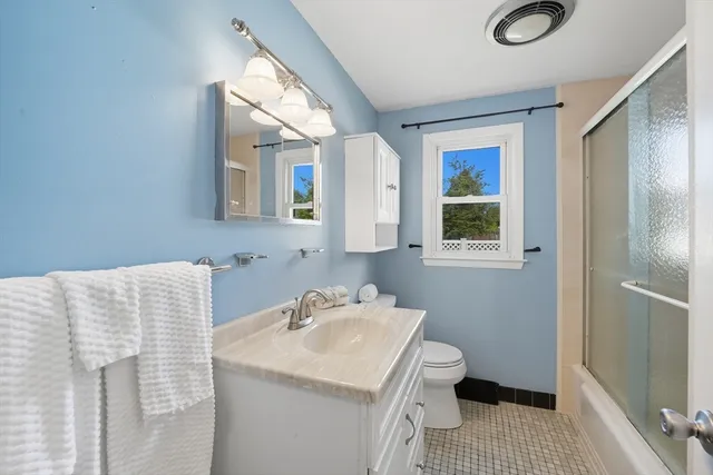 a bathroom with a sink toilet and mirror