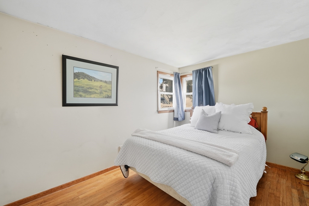 54 Dayton Street Chicopee, MA 01013 - Photo 14 of 25 a bedroom with a bed and a painting on the wall