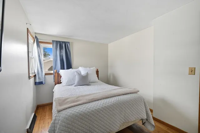 a bedroom with a bed and a mirror