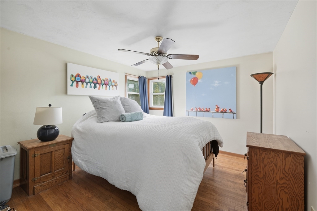 54 Dayton Street Chicopee, MA 01013 - Photo 16 of 25 a bedroom with a bed and a chandelier