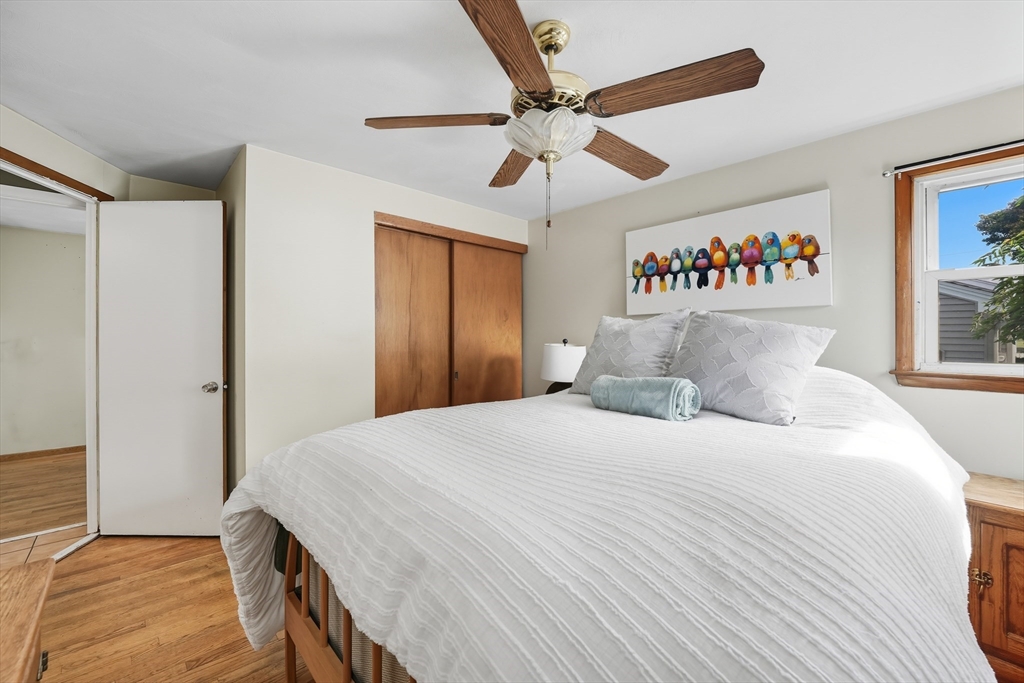 54 Dayton Street Chicopee, MA 01013 - Photo 17 of 25 a bedroom with a large bed and a chandelier