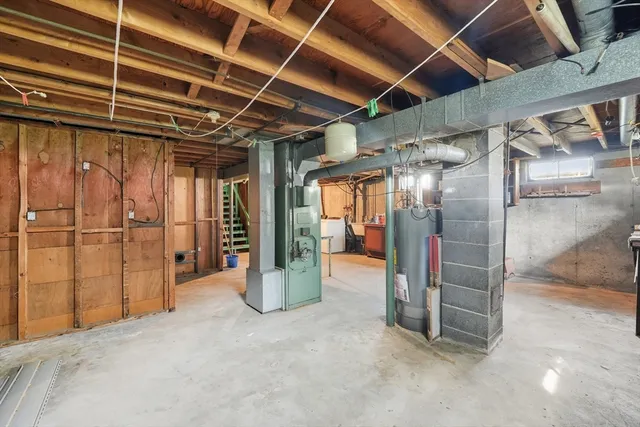 a view of water heater room with wooden walls