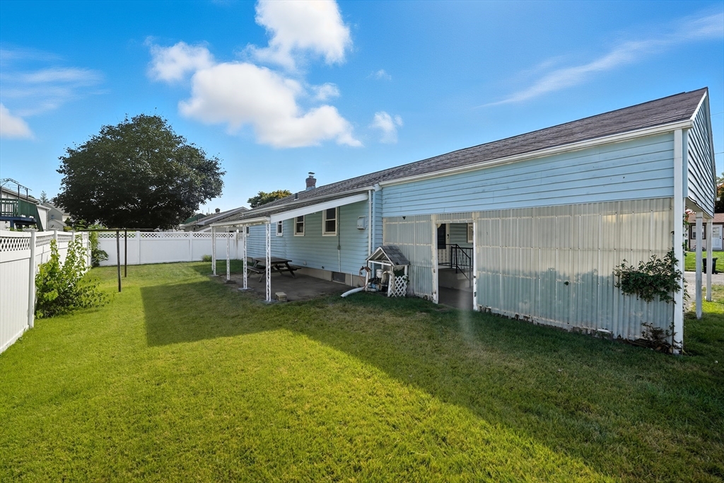 54 Dayton Street Chicopee, MA 01013 - Photo 22 of 25 a view of a backyard with table and chairs and garden