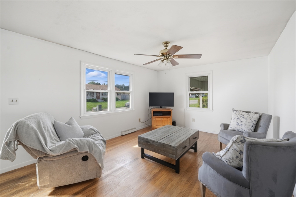 54 Dayton Street Chicopee, MA 01013 - Photo 6 of 25 a living room with furniture a flat screen tv and a large window