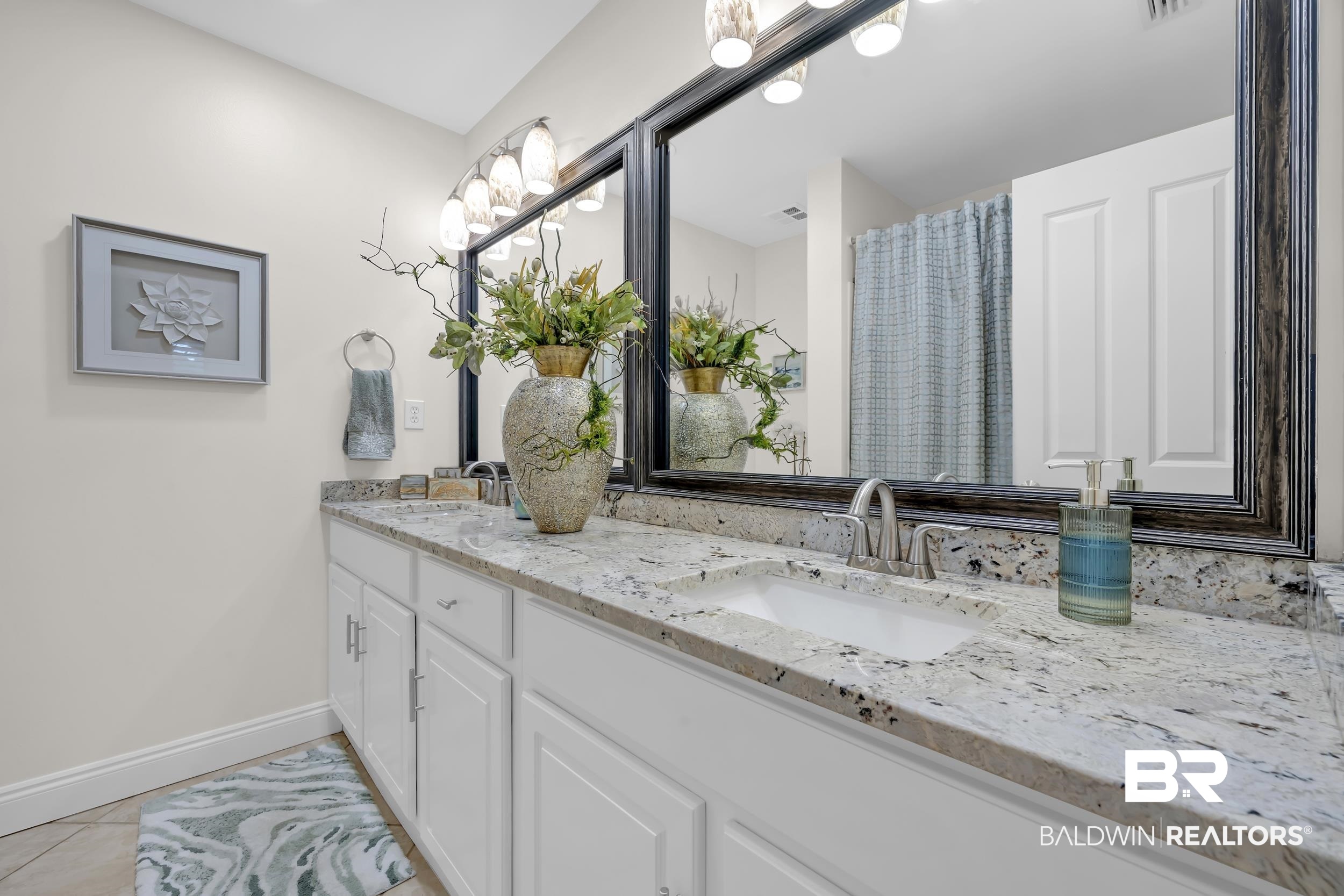 28250 Canal Road, Unit 307 Orange Beach, AL 36561 - Photo 42 of 56 Bathroom featuring double vanity, a shower with shower curtain, and light tile patterned flooring