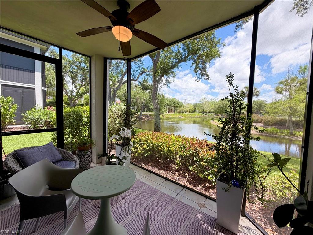 2377 Ravenna Boulevard, Unit 101 Naples, FL 34109 - Photo 11 of 19 a room with a large window and table or chairs