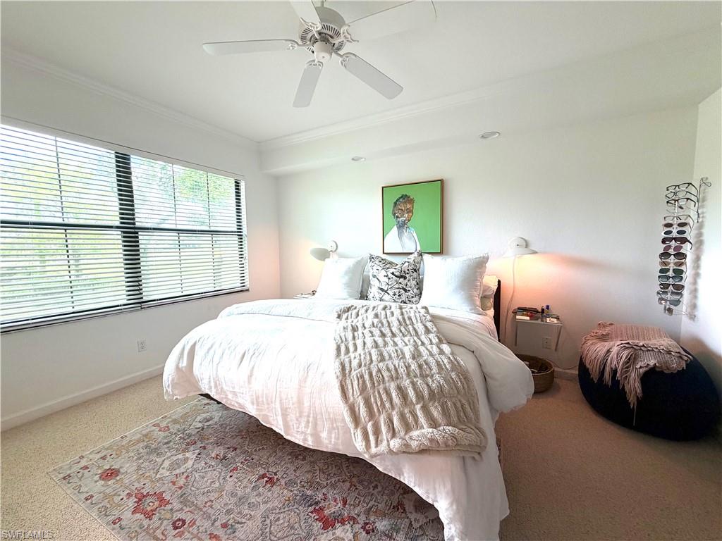2377 Ravenna Boulevard, Unit 101 Naples, FL 34109 - Photo 13 of 19 a bedroom with two beds and a window