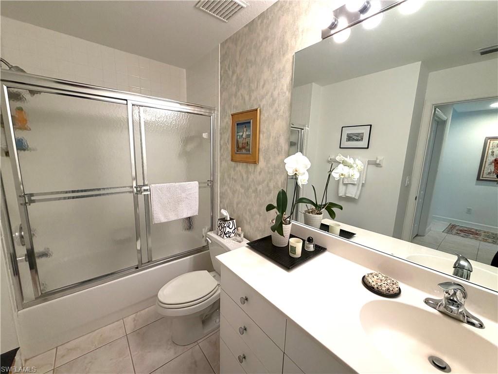 2377 Ravenna Boulevard, Unit 101 Naples, FL 34109 - Photo 15 of 19 a bathroom with a sink toilet and shower