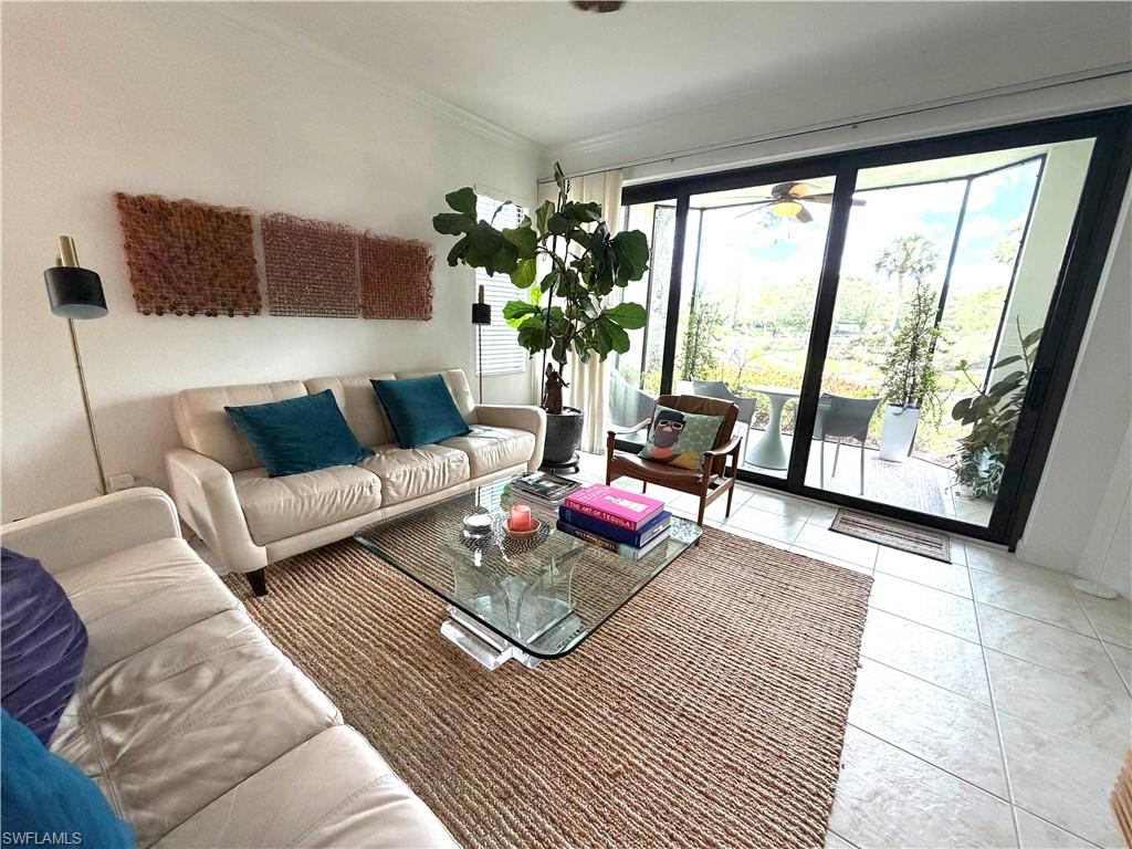 2377 Ravenna Boulevard, Unit 101 Naples, FL 34109 - Photo 3 of 19 a living room with furniture and a large window