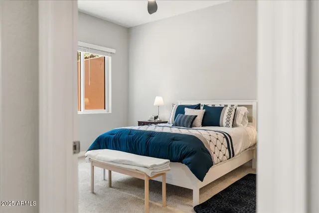 a bedroom with a bed and a table in it