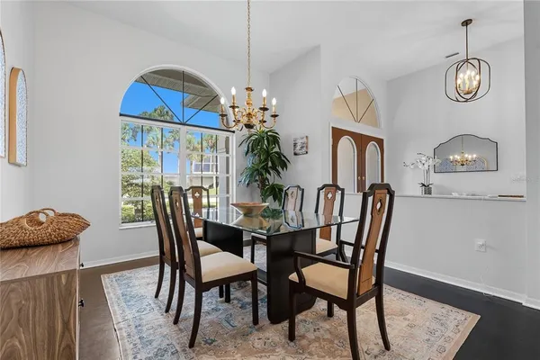 a view of a dining room with furniture and a chandelier fan
