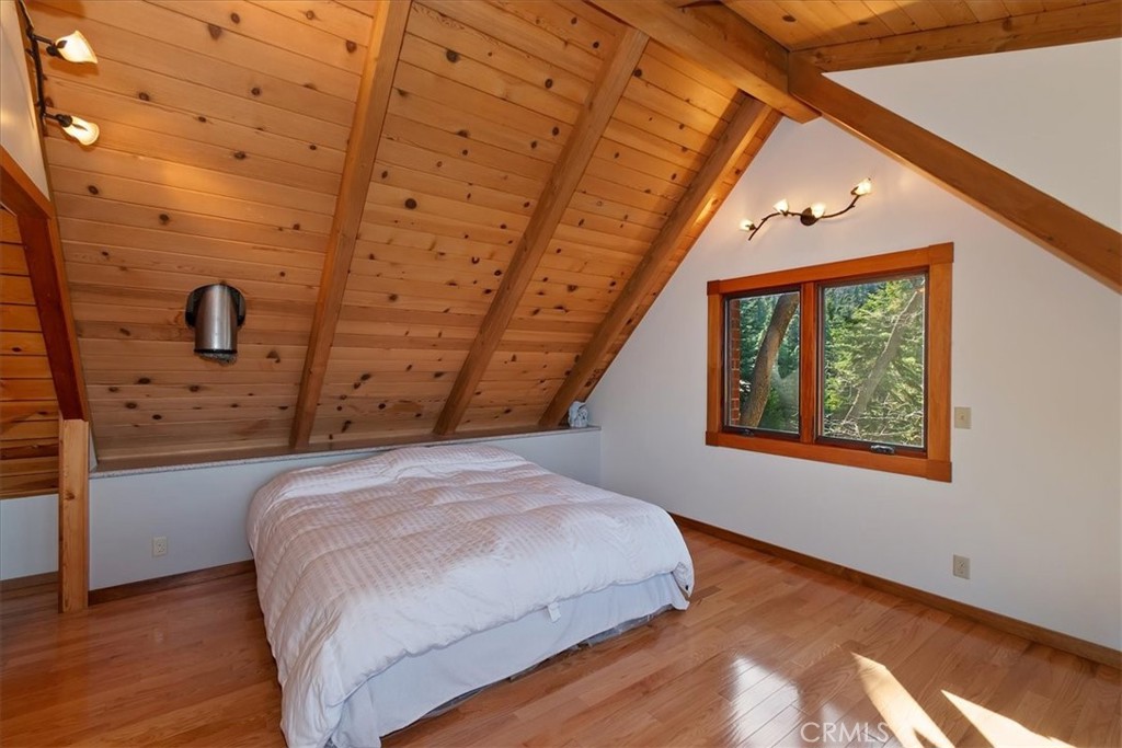 495 Kuffel Canyon Road Lake Arrowhead, CA 92352 - Photo 28 of 64 a bedroom with a bed and a dresser