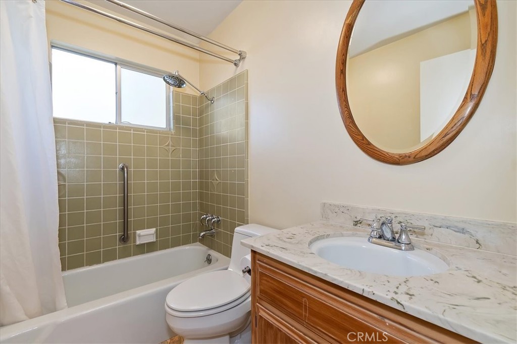 495 Kuffel Canyon Road Lake Arrowhead, CA 92352 - Photo 39 of 64 a bathroom with a granite countertop sink a toilet and a mirror
