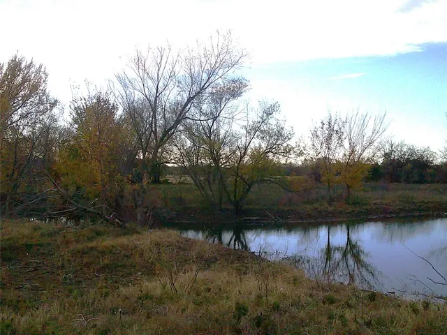 a view of lake with a yard