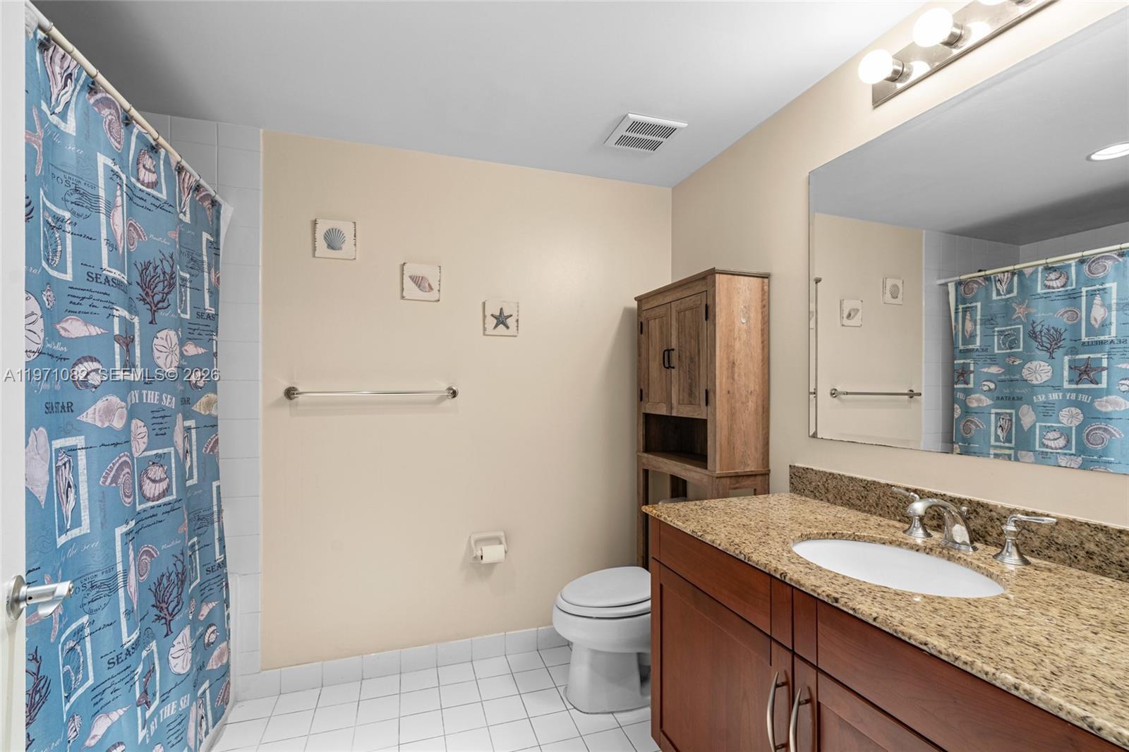 7275 Southwest 90th Way, Unit 404 Miami, FL 33156 - Photo 20 of 35 a bathroom with a granite countertop sink toilet and shower