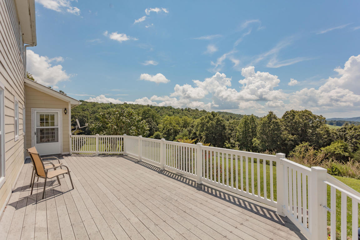 1236 Dutch Hollow Road Raphine, VA 24472 - Photo 15 of 45 a view of a balcony with wooden floor and iron fence