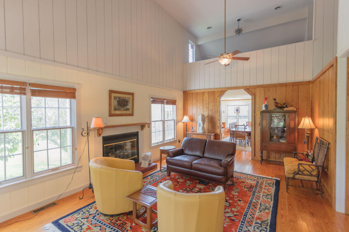 1236 Dutch Hollow Road Raphine, VA 24472 - Photo 18 of 45 a living room with furniture a fireplace and a table
