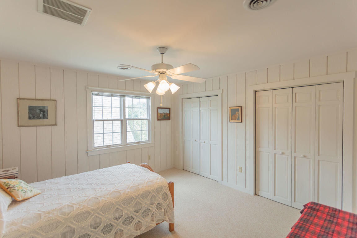 1236 Dutch Hollow Road Raphine, VA 24472 - Photo 39 of 45 a bedroom with a bed and a chandelier
