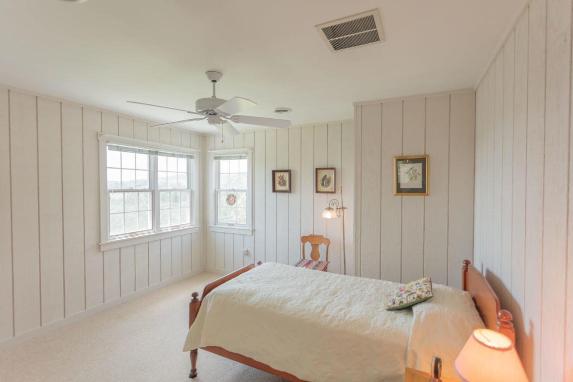 1236 Dutch Hollow Road Raphine, VA 24472 - Photo 42 of 45 a bedroom with a bed and a chandelier