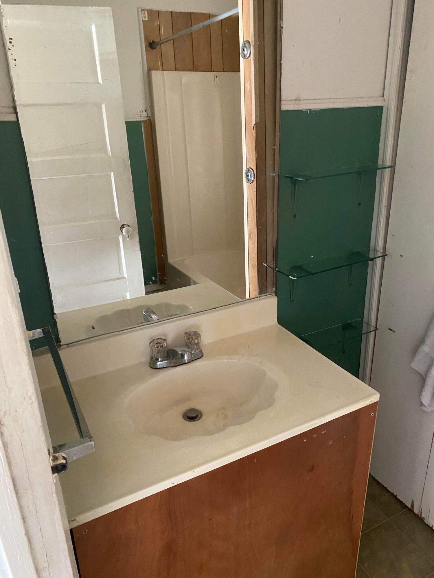 145 Live Oak Avenue West DeFuniak Springs, FL 32435 - Photo 12 of 25 a bathroom with a sink and a mirror