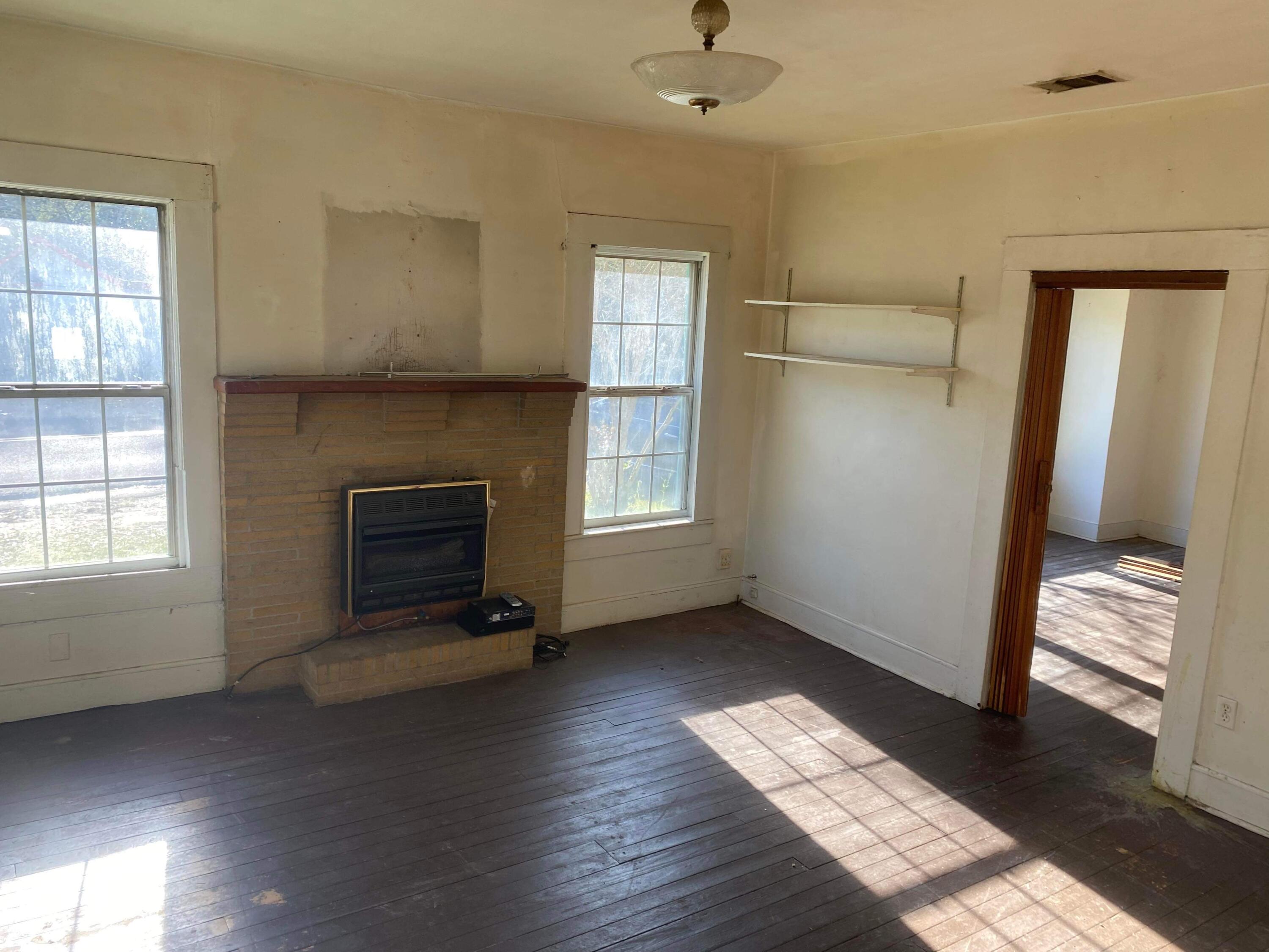 145 Live Oak Avenue West DeFuniak Springs, FL 32435 - Photo 13 of 25 an empty room with windows and fireplace