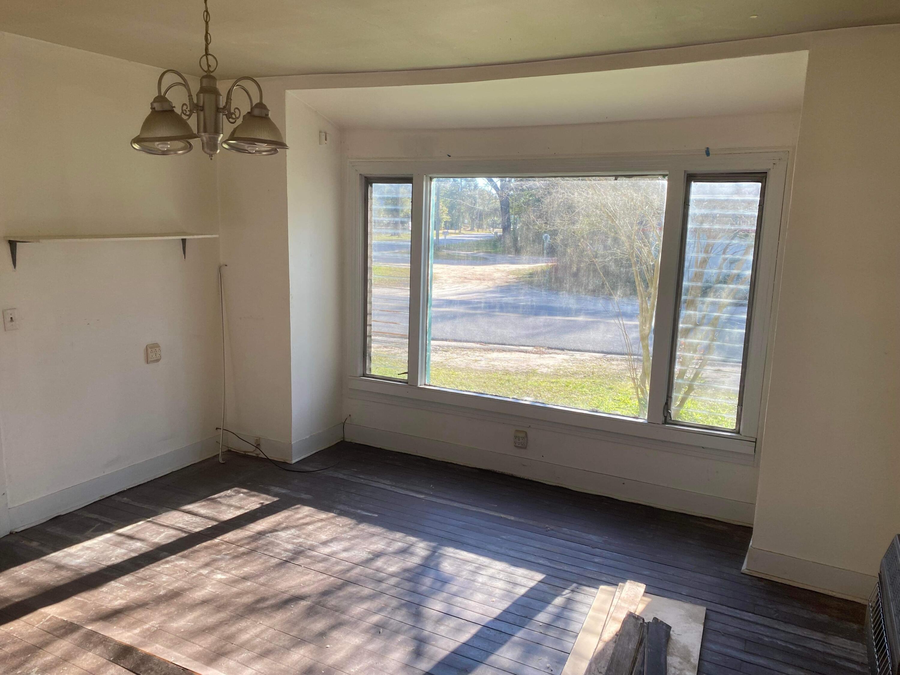 145 Live Oak Avenue West DeFuniak Springs, FL 32435 - Photo 3 of 25 a view of an empty room and window